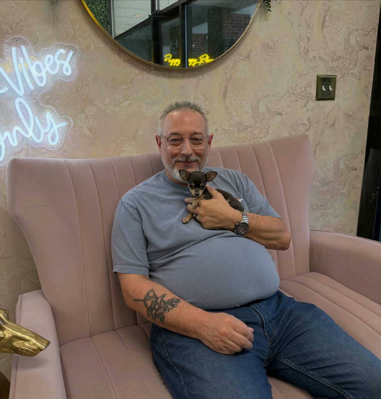 A first-time Chihuahua dad holding his puppy