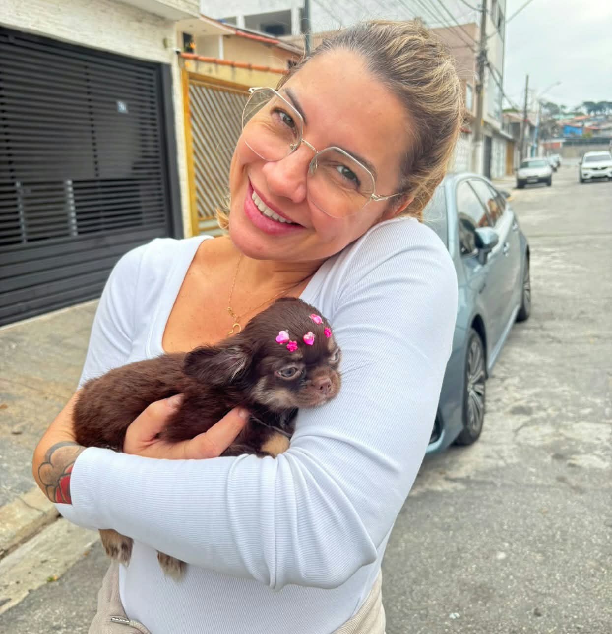Anna holding her Chihuahua puppy